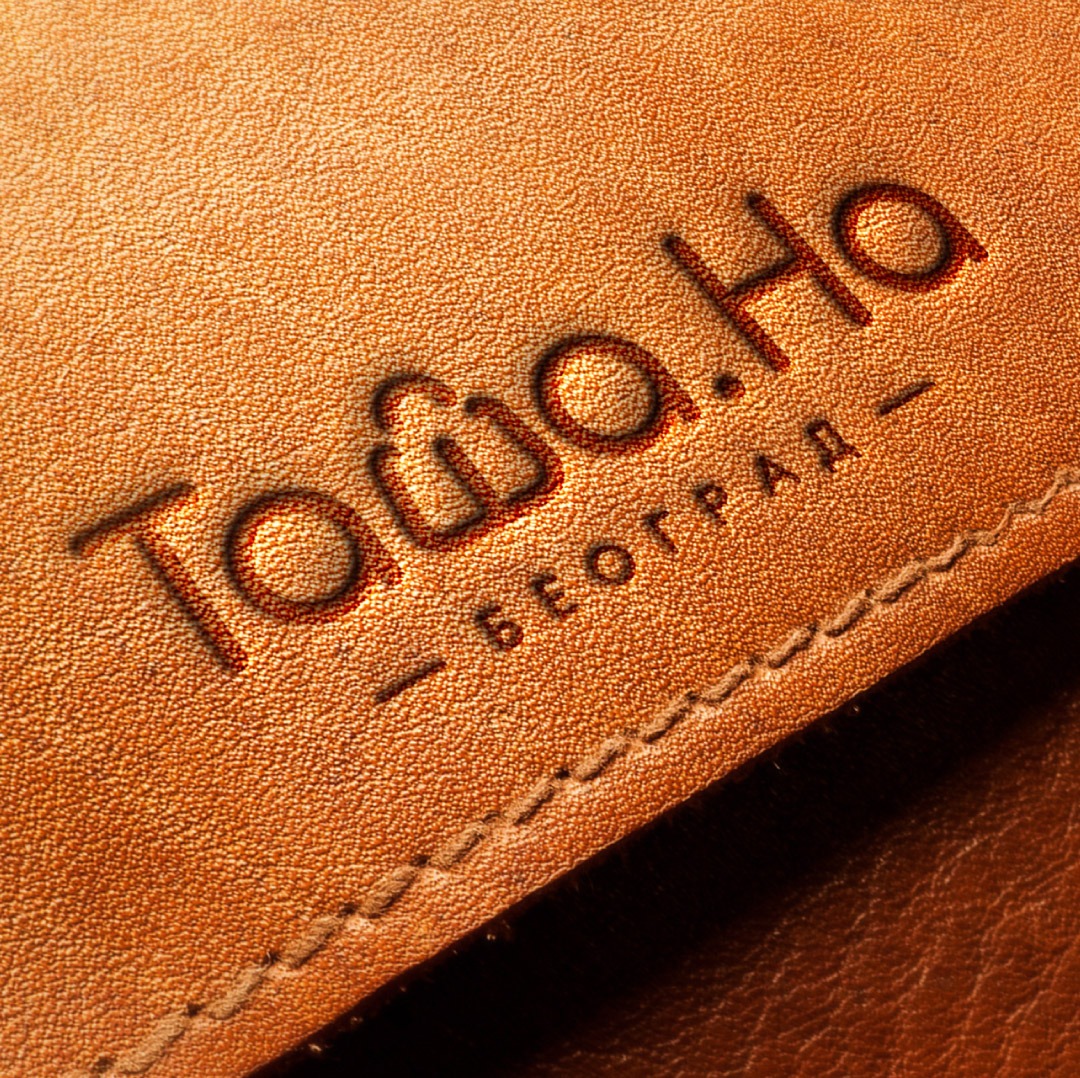 The wordmark debossed into leather
